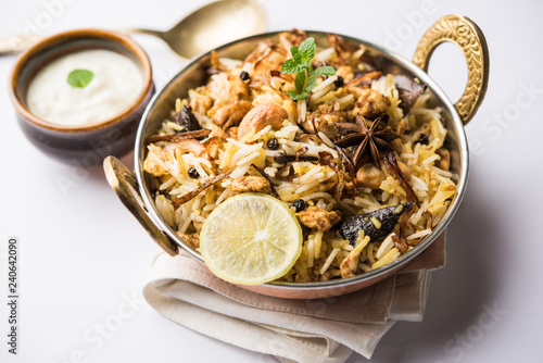 Keema or Kheema Biryani - Fragrant and spicy minced lamb or goat or chicken cooked in range of aromatic spices with basmati rice. served in a karahi with curd. selective focus photo