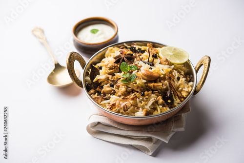 Keema or Kheema Biryani - Fragrant and spicy minced lamb or goat or chicken cooked in range of aromatic spices with basmati rice. served in a karahi with curd. selective focus
