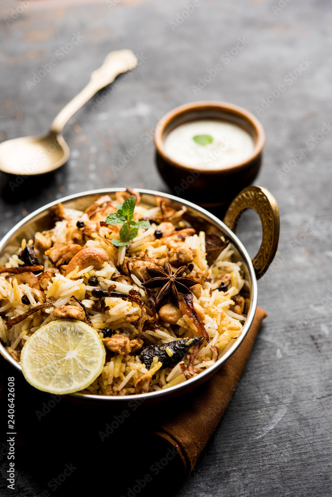 Keema or Kheema Biryani - Fragrant and spicy minced lamb or goat or chicken cooked in range of aromatic spices with basmati rice. served in a karahi with curd. selective focus Keema or Kheema Biryani - Fragrant and spicy minced lamb or goat or chicken cooked in range of aromatic spices with basmati rice. served in a karahi with curd. selective focus