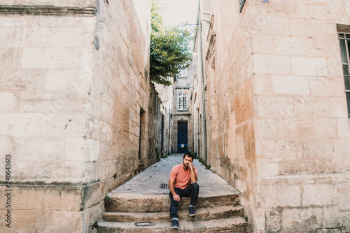 .Young man doing sightseeing around the beautiful city of Bordeaux in France. Feeling free and happy discovering new places. Travel photography. © lubero
