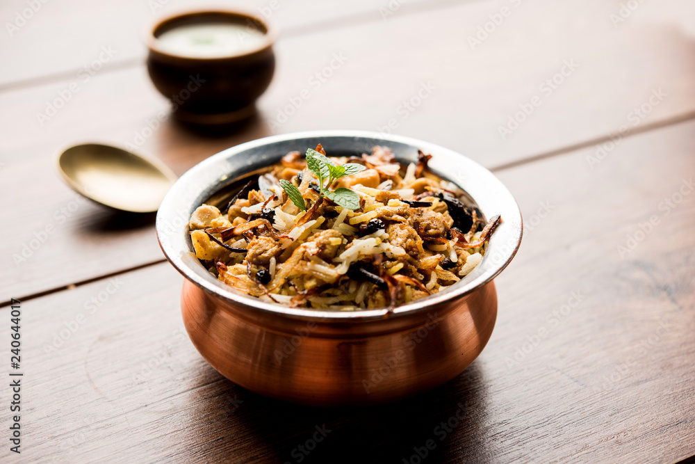 Keema or Kheema Biryani - Fragrant and spicy minced lamb or goat or chicken cooked in range of aromatic spices with basmati rice. served in a karahi with curd. selective focus Keema or Kheema Biryani - Fragrant and spicy minced lamb or goat or chicken cooked in range of aromatic spices with basmati rice. served in a karahi with curd. selective focus