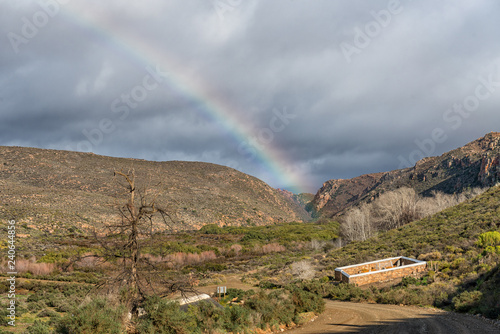 Historic cemetery and a rainbow at Matjiesrivier Nature Reserve photo