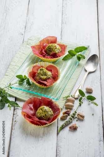 ricotta cheese meatballs with pisctachio nuts over bresaola
