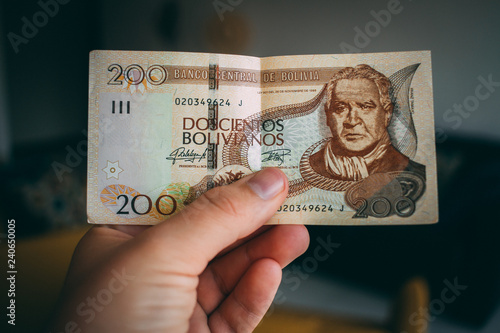 Hand holding Bolivian money photo