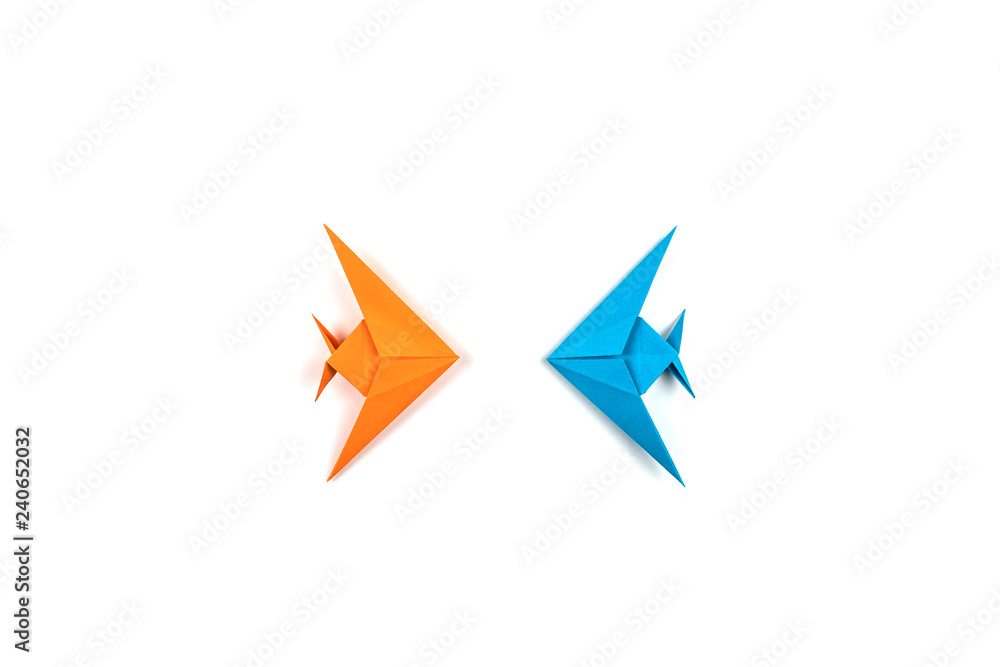 Fototapeta premium Two origami fishes isolated on white background.