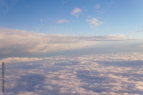 Sky with clouds at sunset from inside the plane landscape