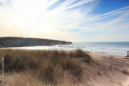 Dunes in a sandy beach at the sunset