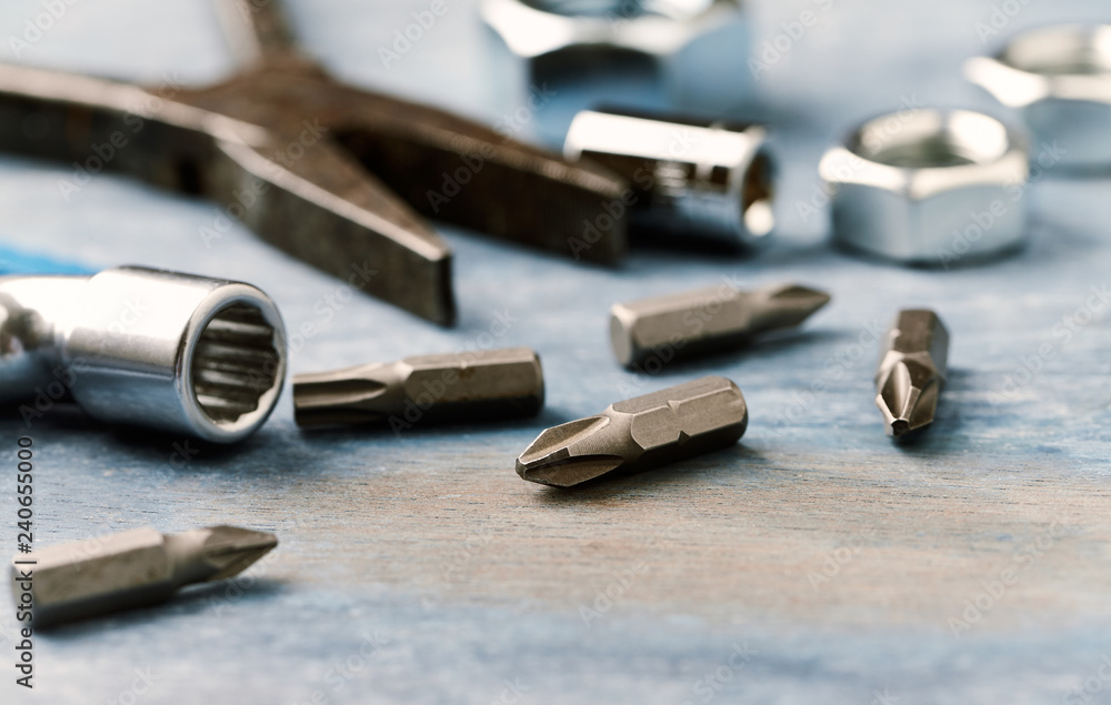 Bits for a screwdriver and socket wrench on wooden background. Close up. Bits for a screwdriver and socket wrench on wooden background. Close up.