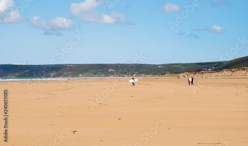Landscape near Biville in Normady. Man and two female friends with surfboards. Second world war bunker on beach. France