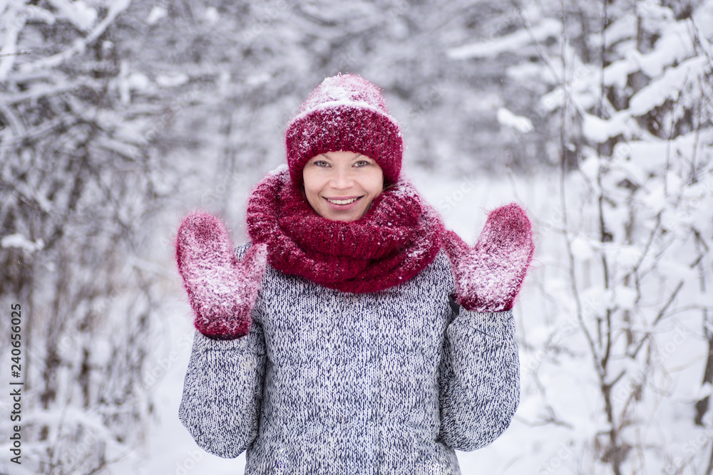 Girl in the red hat and a scarf having fun in the winter park. Girl in the red hat and a scarf having fun in the winter park.