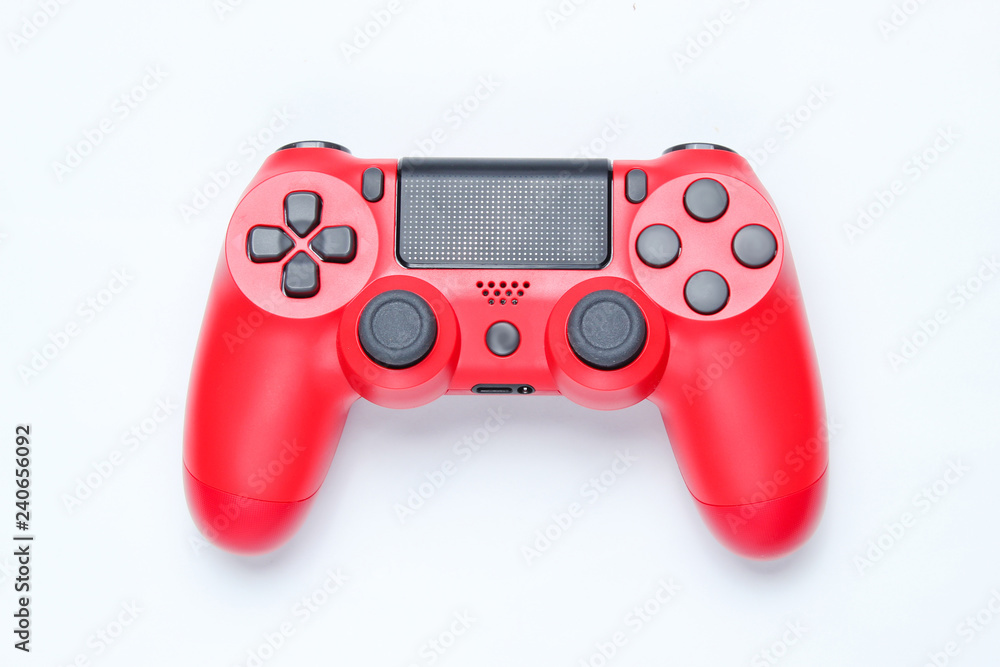 Modern red gamepad (joystick) on gray background. Top view. Modern red gamepad (joystick) on gray background. Top view.