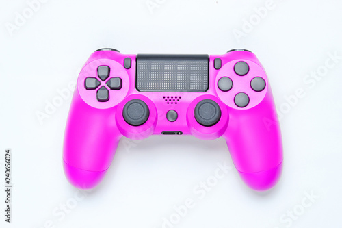 Modern pink plastic gamepad (joystick) on gray background. Top view.