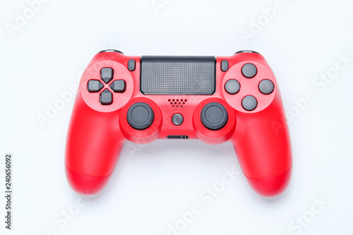 Modern red gamepad (joystick) on gray background. Top view.