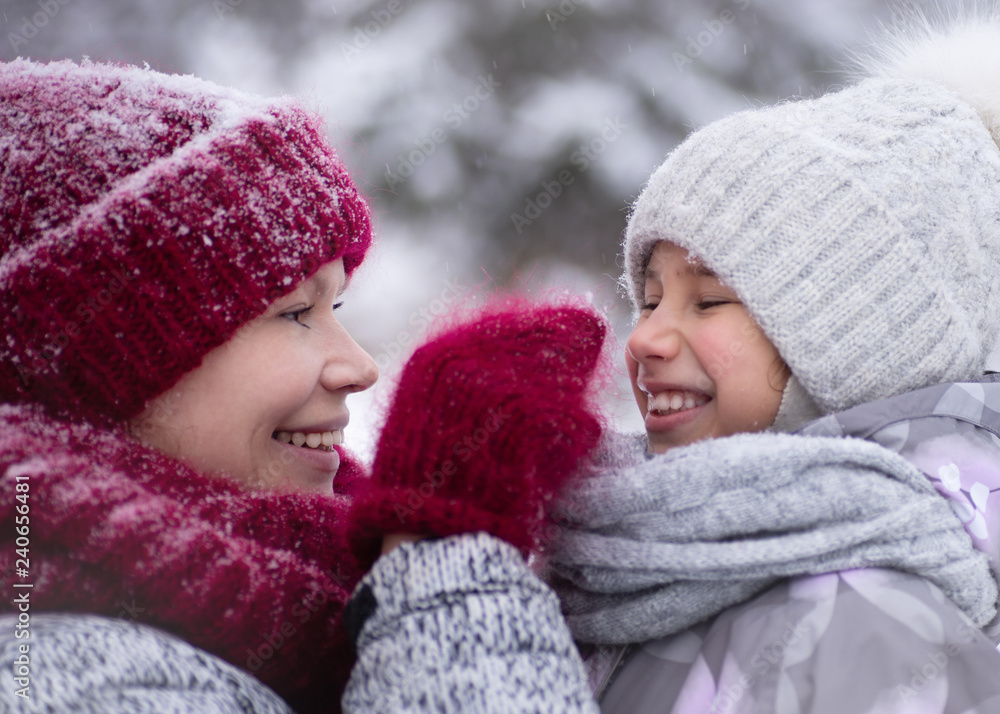 Happy family mother and child daughter having fun, playing at winter walk outdoors. Happy family mother and child daughter having fun, playing at winter walk outdoors.