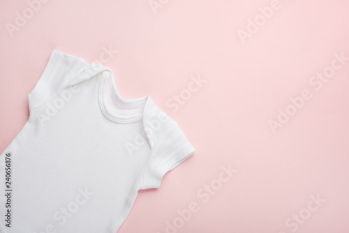 Layout Flat Lay white baby shirt bodysuit, on a pink background, for girls. Mock up for design and placement of logos, advertisements