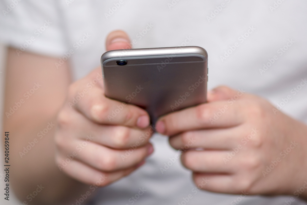 baby hands hold smart phone on blurred background. For graphic displey montage. baby hands hold smart phone on blurred background. For graphic displey montage.