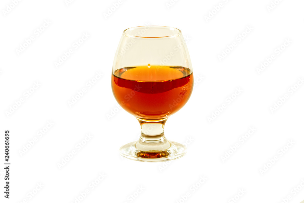A glass of whiskey with ice or brandy and a square carafe isolated on a white background. Whiskey with ice in a glass against white background. A glass of whiskey with ice or brandy and a square carafe isolated on a white background. Whiskey with ice in a glass against white background.