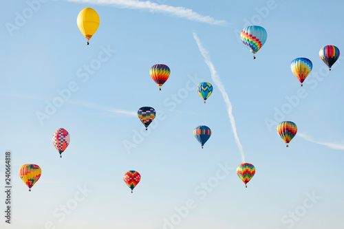 Multi colored hot air balloon flying over blue sky