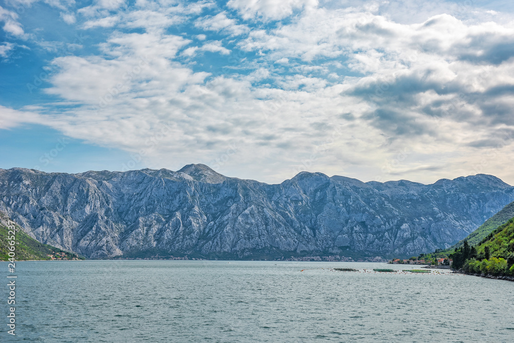 Lake with big mountains, adreatic in Montenegro in calm waters of sea, panoramic view