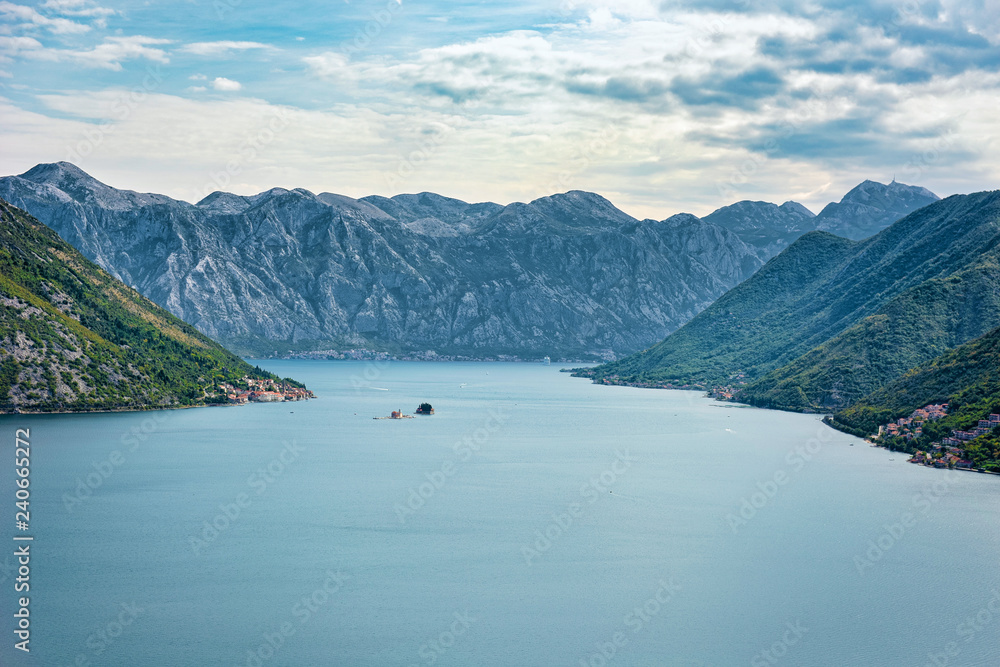 Panorama of lake with mountain with island, adreatic in Montenegro in calm waters of lake