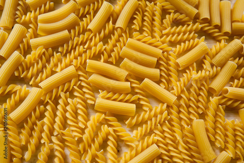 Uncooked pasta Rigatoni and Fusilli on wooden background. Cooking concept. Top view - Image