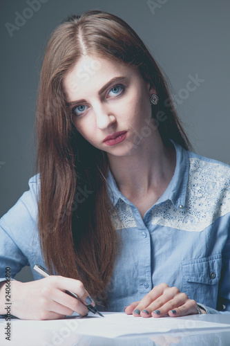 The filing of a tax return concept. Business woman writin the information about income  in tax form. photo