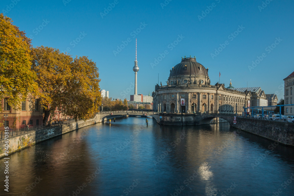 Berlin cityscape with museum island and the river Spree in autumn. In the background the TV tower is visible in the blue sky on sunny day
