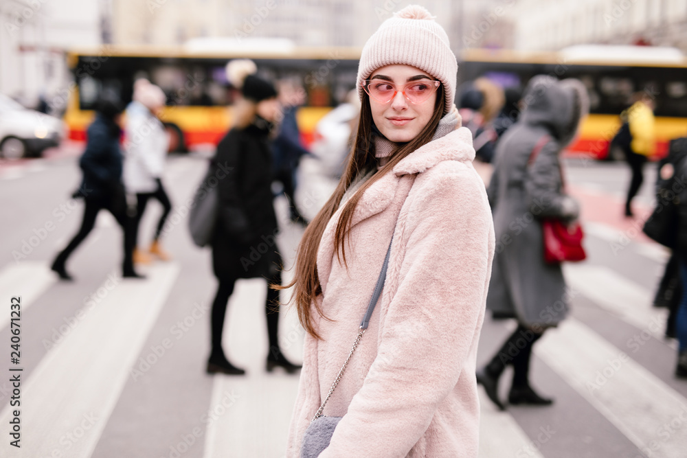 Fashion woman walking on the city street, wear pantone color jaket with pink glasses and look to camera. Copy space. - Image Fashion woman walking on the city street, wear pantone color jaket with pink glasses and look to camera. Copy space. - Image