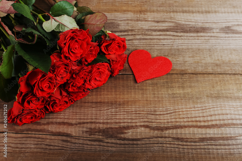 Red roses and hearts on wooden table. Concept of Women's Day or St. Valentine. Copy space. Red roses and hearts on wooden table. Concept of Women's Day or St. Valentine. Copy space.