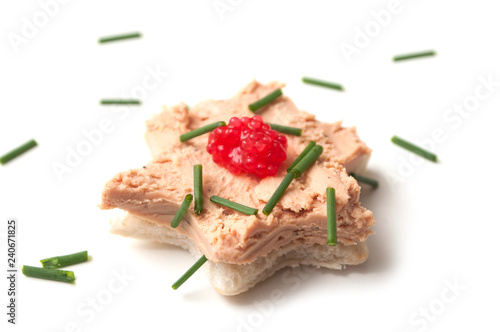 closeup of foie gras on bread in shaped star on white background