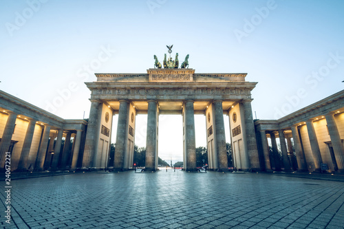 Brandenburg Gate in the center of Berlin near the Paris Place. Brandenburg Gate without people in blue sky is illuminated by light.