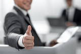 businessman shows thumb up