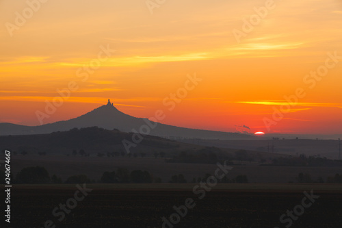 The silhouette of Hazmburk Castle at sunrise.Czech Republic.