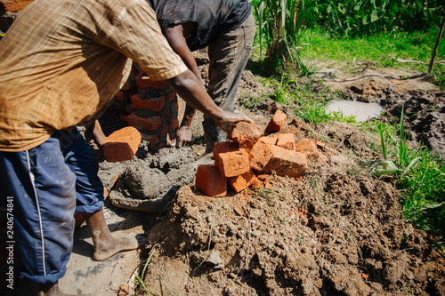 man building a house in Uganda, Africa