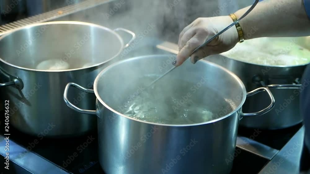 The cook prepares the Georgian national food of Khinkali. Boil in the pan meat in the dough. The cook prepares the Georgian national food of Khinkali. Boil in the pan meat in the dough.
