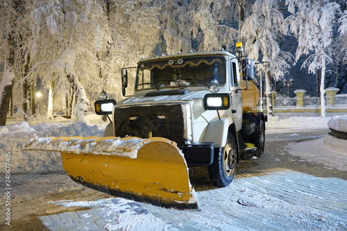 Beautiful snowy winter in Kiev, Ukraine, a lot of snow on the evening streets, snow removal machine