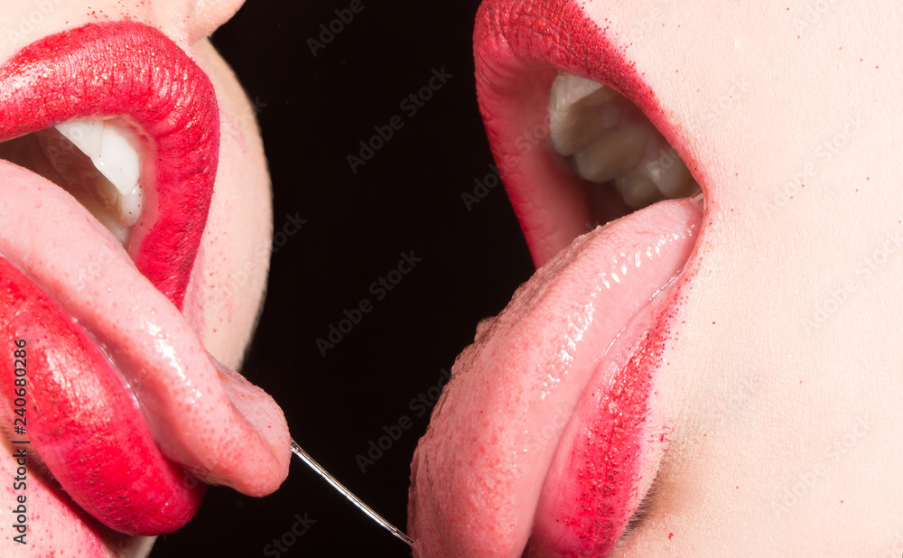 Lesbian kiss. Passion between women. Female lips with red lipstick. Close  relations. Homosexual sex. Pride. Same-sex marriage. Sexy kiss. Seductive  feminine tongue in mouth with saliva. French Kiss foto de Stock