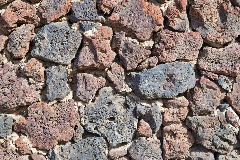 Fototapeta premium The decorative fence surface of volcanic lava.