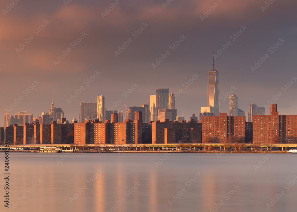 Fototapeta premium View on Midtown Manhattan from east river at sunrise with long exposure