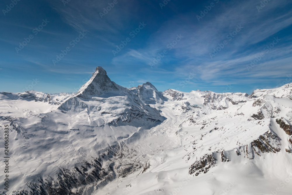 Aerial view of majestic Matterhorn mountain in front of a blue sky.