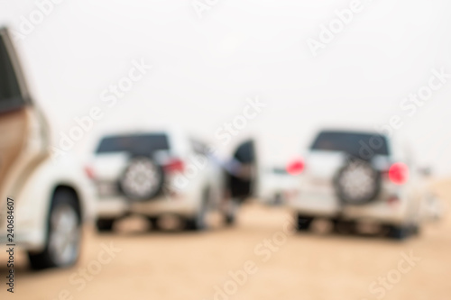 SUVs travel through desert dunes,  image out of focus © Valerii Dekhtiarenko
