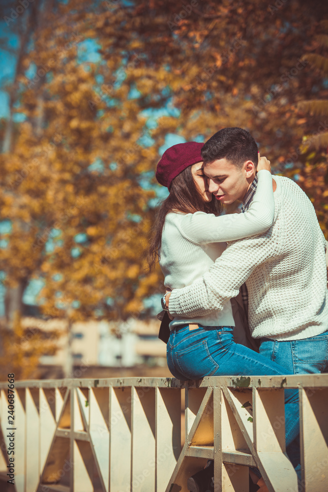 Fototapeta premium Girlfriend kissing her boyfriend in the park