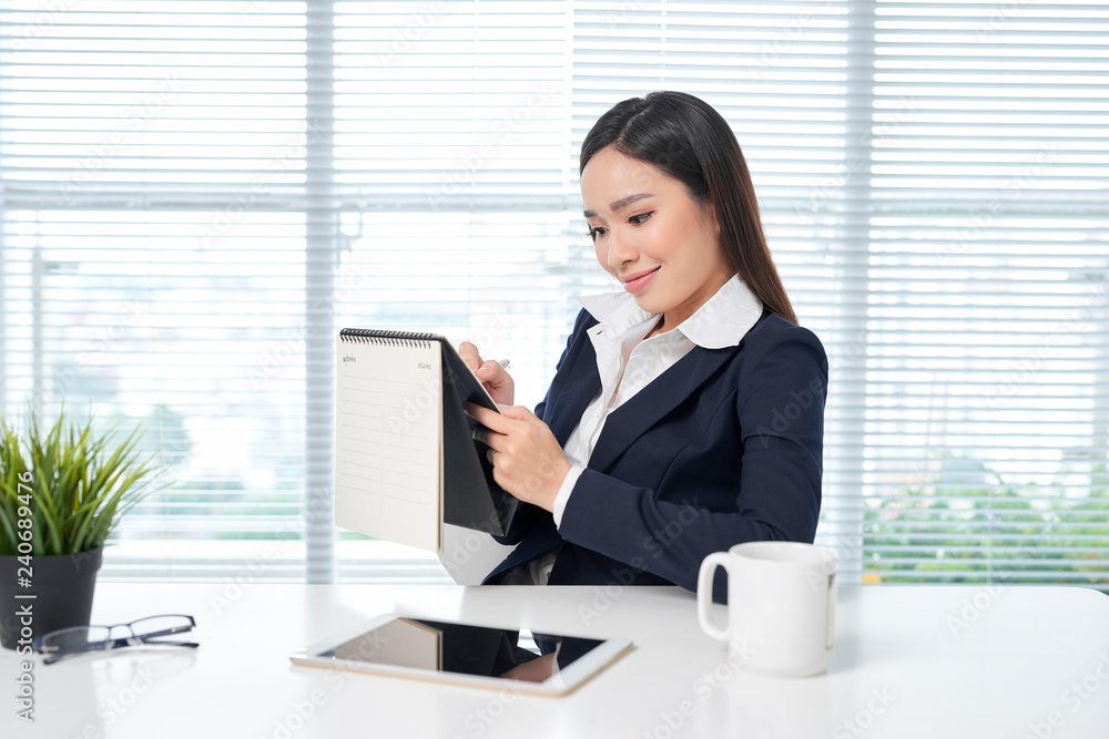 businesswoman hand with pen writing on calendar for note or make appointment concept. businesswoman hand with pen writing on calendar for note or make appointment concept.