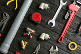 Flat lay composition with plumber's tools on wooden background