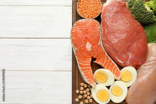 Fotografie Set of natural food high in protein and space for text on wooden background, top