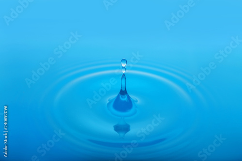 Splash of blue water with drop as background, closeup