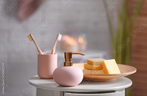 Aromatic soap and shampoo on table against blurred background. Space for text
