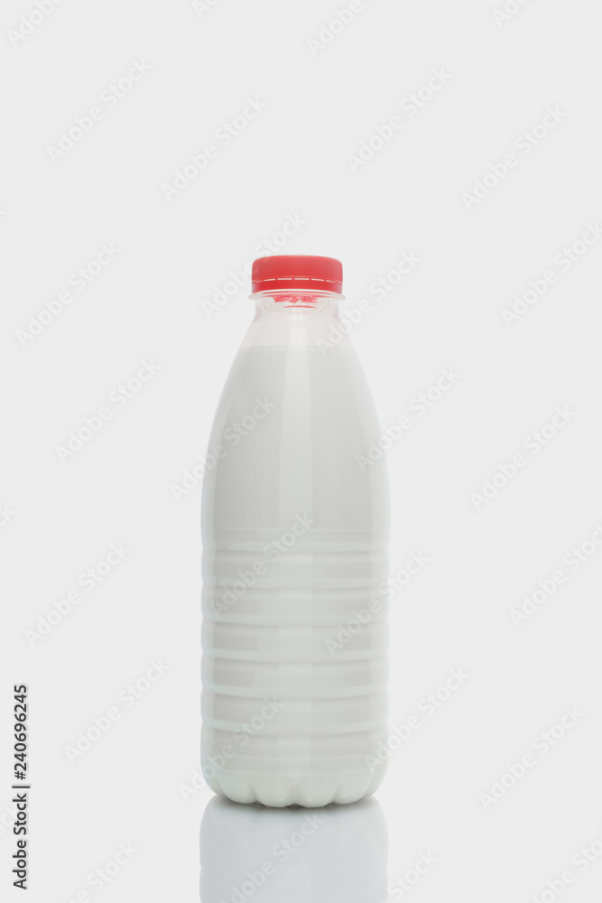 Milk bottle with red cap isolated on white background Milk bottle with red cap isolated on white background
