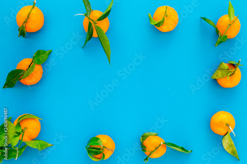 branch of mandarins for New Year and Christmas celebration on blue background top view mockup