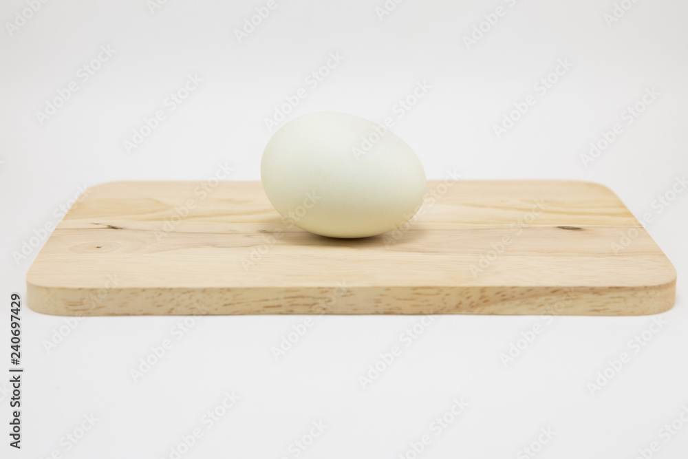 Fresh white eggs on a wooden cutting board Fresh white eggs on a wooden cutting board